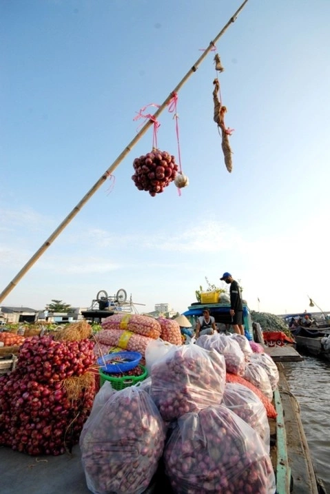 Sellers hang samples of their goods on long bamboo poles — a system called cây bẹo